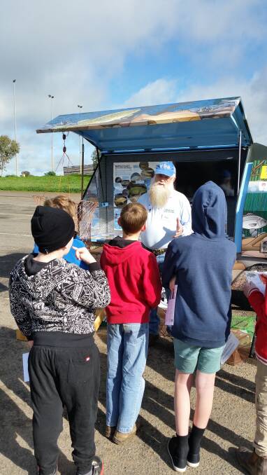 NSW Fishcare Volunteer: Russell Spencer promoting responsible fishing to children at Eco Day. Photographs can be taken at the location where the fish is landed.