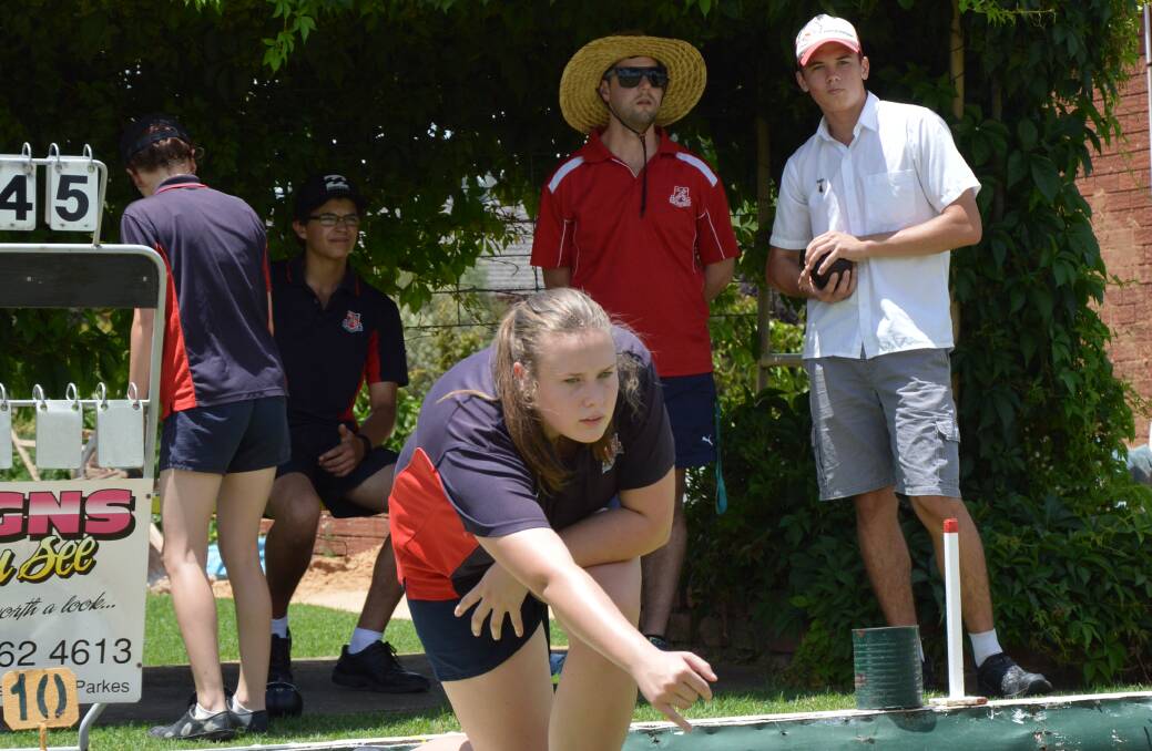 EFFORT: Kaitlyn Macdonald throws a lot of concentration behind her bowls at Parkes High School Year 11 social bowls at Railway Bowling Club. Photo: Christine Speelman.