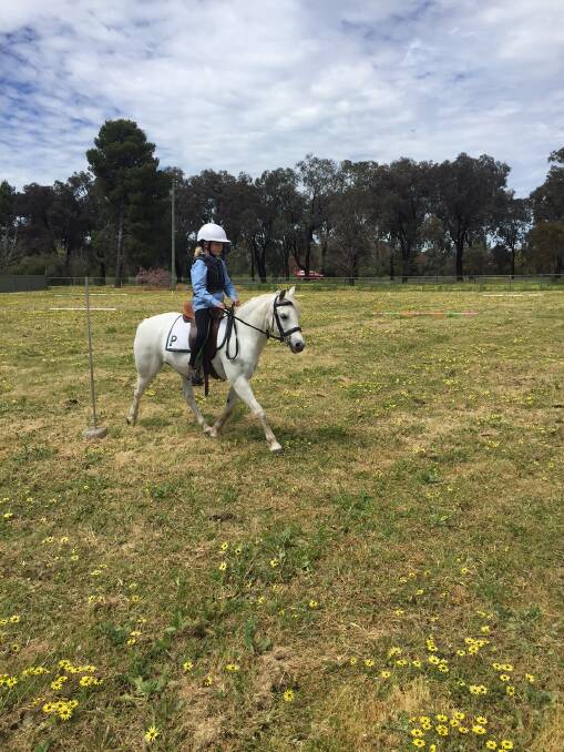 Lucy Chapman riding Penny in the bending race at the Parkes Pony club Mini Olympics. 