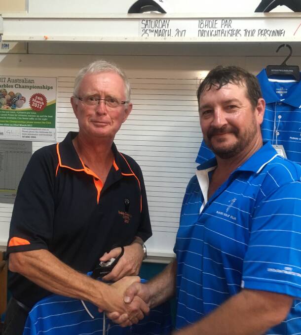 Cowra golfer Paul Smith receives congratulations from Droughtbusters Tour Member Brian Hogan on winning the C Grade trophy.