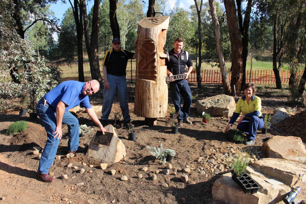 PLACE OF PEACE: Parkes Rotary President David Hughes,  Parkes Rotary Secretary Ken Engsmyr, local artist Sean Cassidy and Parkes Shire Council's Parks & Gardens Technical Officer Elizabeth Briton working on the new Rotary Peace Precinct.  