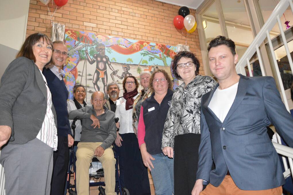 Pictured at the unveiling of the artwork "Unity - Ngumba-da", from left - Julie Bradley (Western area Manager Aged care Plus), Carel Bothma (Executive Manager Human Resources Aged Care Plus), Carol Towney, Lloyd Barber (Residents representative), Scott Sauce Towney (Artist), Envoy Rosemary Richardson (Chaplain Rosedurnate), Eileen Newport  (Lachlan Region reconciliation), Sue Tate (Parkes Early Childhood Centre), Leona Fisher (Centre Manager Rosedurnate), Sean Cassidy (Artist). Photo by Barbara Watt.