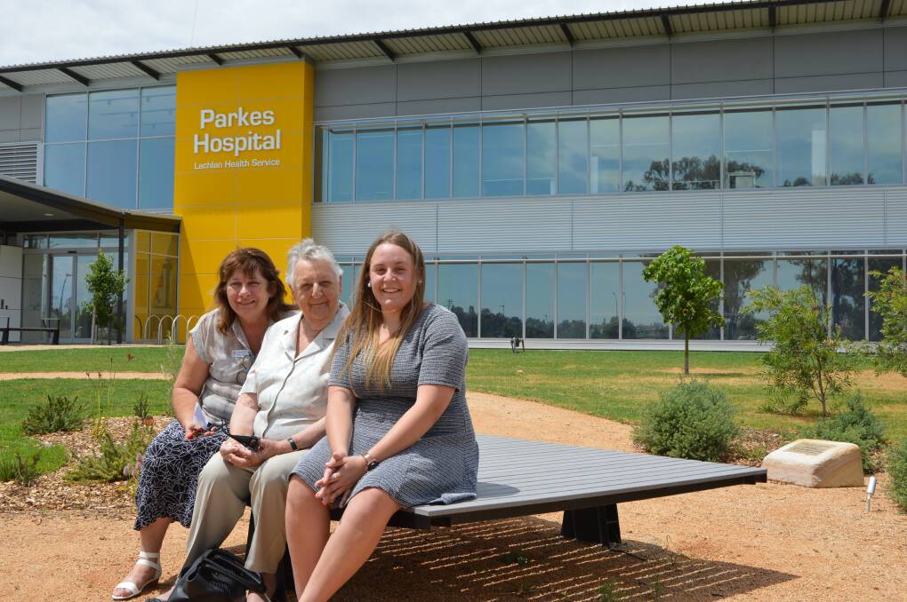 Liz Mitchell (Health Services Manager, Lachlan Forbes and Parkes) with Deborah Hunter's  mother, Marg Cherry, and daughter, Meg Hunter, in the memorial garden built in her memory. 