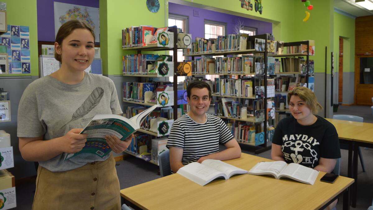 CRAMMING: Parkes High School students Chloe Henderson (Vice Captain 2017), Ross Collins (Captain 2017) and Tianna Allen get some study done in the school library.
