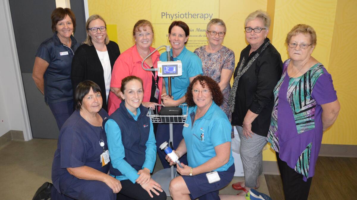 Pictured with the new PhysioTouch machine at the Parkes Hospital Physiotherapy Department, from left - Leone Stevenson (representative from the Pink Golf fundraising day), Rebecca Rawsthorne (hosted a fundraiser for the machine in memory of her mum, Miriam Helby, who died of breast cancer in 2011), Di Green (Lachlan Health Service McGrath Breast Care Nurse), Rochelle Smith (Physiotherapist), Kath Gleeson (Community & Allied Health Manager), Carolyn Rice (Parkes Quota Inc), Adrianne Brown (Can Assist); kneeling - Karen Swindle (Can Assist), Sarah Hartin (Physiotherapist) and Cheryl Uptin (Physiotherapy Assistant). Photo by Barbara Watt. 