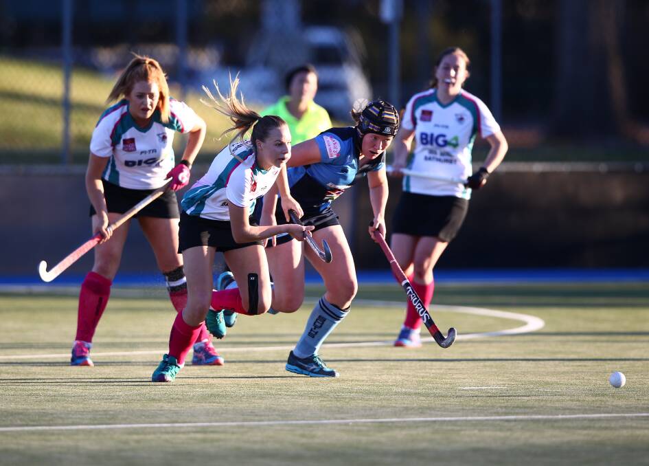 CHARGE: Bec Bosianek and Sarah Watterson in pursuit of the ball during the last City-Souths meeting. Photo: PHIL BLATCH