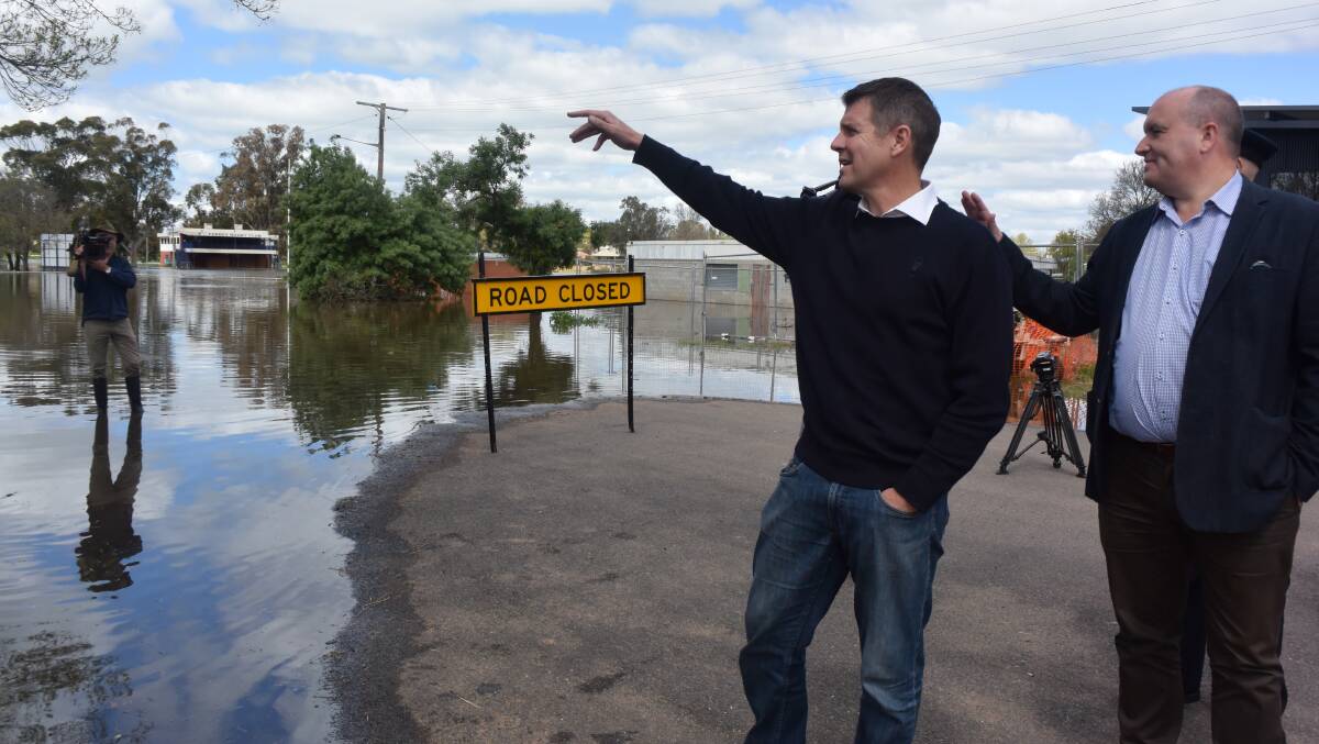 NSW Premier Mike Baird assesses flood damage in Forbes with Minister for Emergency Services David Elliot. 