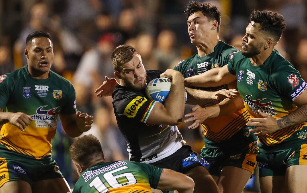 POWER: Dubbo product and Penrith prop Kaide Ellis muscles up against Wyong defenders, including Justin Toomey-White (right). Photo: NRL PHOTOS