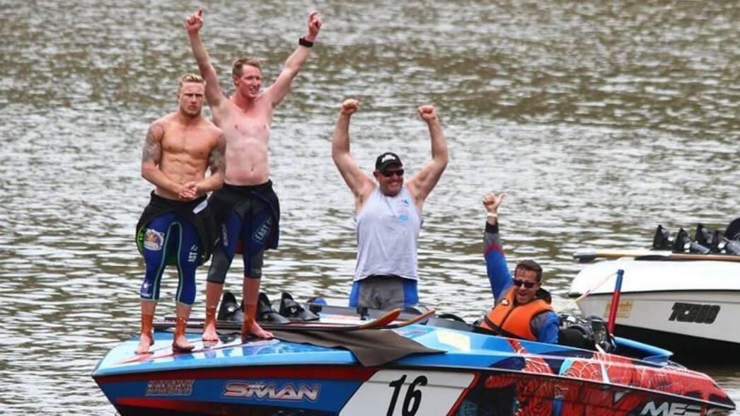 Cowra ski-racer Kris Knights throws his hands in the air with jubilation after winning the Southern 80 on the waters of the Murray River.