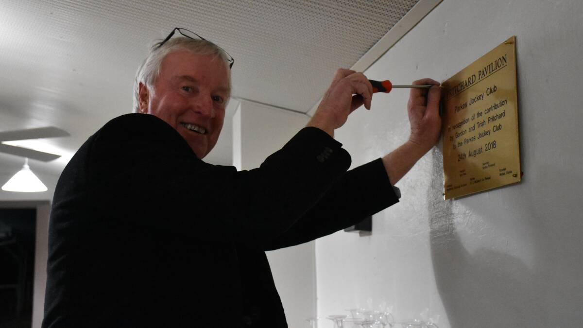 Finishing touches: Builder Tim McCabe puts up the Pritchard Pavilion plaque. Photo: File.