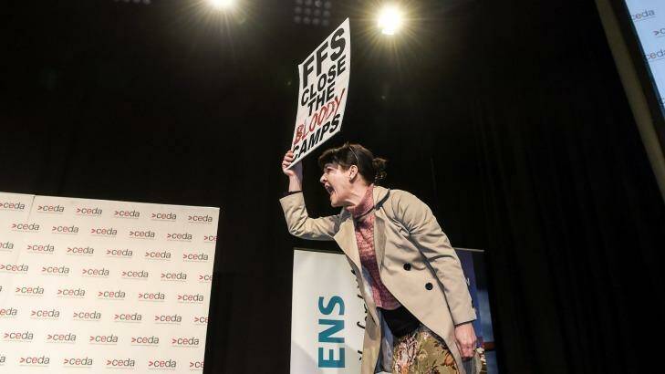 The onstage protester shouts at Prime Minister Malcolm Turnbull while refusing to leave the stage. Photo: Justin McManus