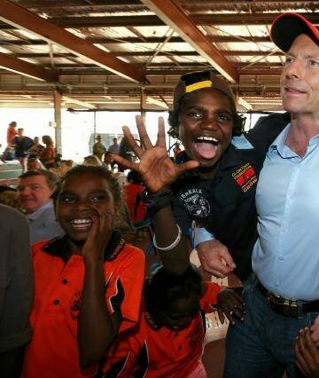 Prime Minister Tony Abbott with excited school children at Yirrkala School during his visit to North East Arnhem Land in September last year. Photo: Alex Ellinghausen