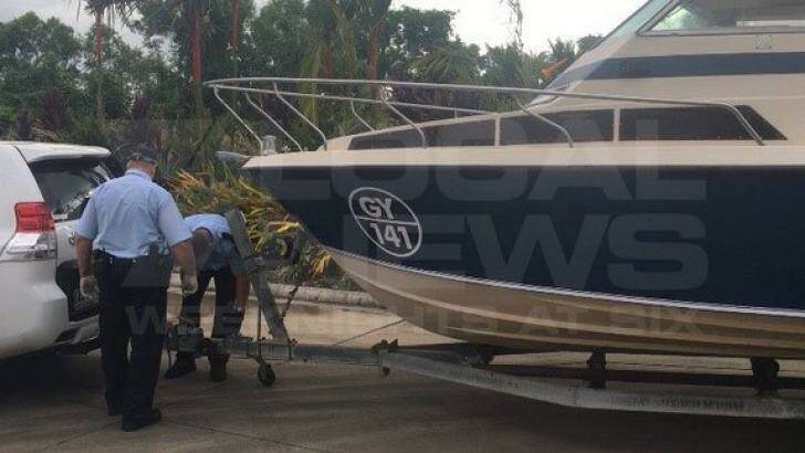 Police examine the boat that the five men towed from Melbourne to Cairns. Photo: Courtesy of Channel 7
