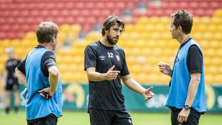 Roar star Thomas ?Broich talks to coach Mike Mulvey ahead of the team's opening A-League match at Suncorp Stadium. Photo: Glenn Hunt