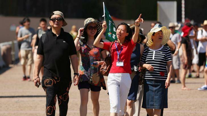 A tour guide leads a group of tourists towards the Sydney Opera House in Sydney: Australia needs to lift its game if it wants to attract more visitors. Photo: Brendon Thorne