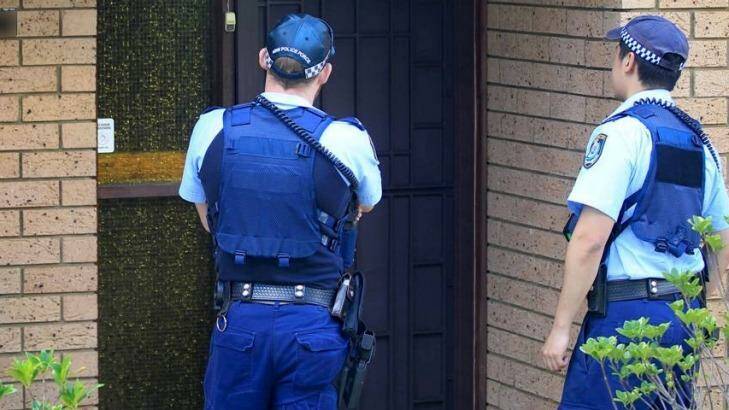 Police officers at the Auburn home of the 16-year-old boy on Monday.  Photo: James Alcock