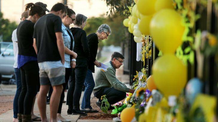 Merrilyn Scott (2nd from right) and Robert Scott (kneeling) pay tribute to their murdered daughter Stephanie Scott. Photo: Kate Geraghty