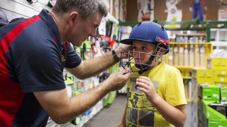 My size: Cooper Sullivan, 9, from Engadine, having his helmet fitted by Geoff Milliken from Kingsgrove Sports Centre. Photo: James Brickwood