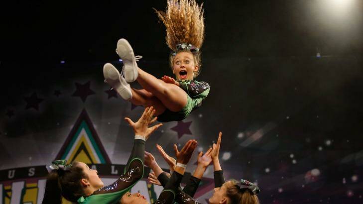 What a throw ... performing at the cheerleading competition. Photo: Darrian Traynor