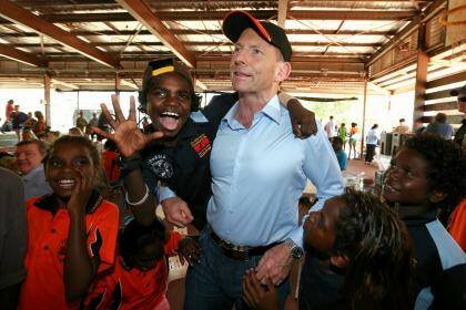 Prime Minister Tony Abbott with excited school children at Yirrkala School during his visit to North East Arnhem Land in September last year. Photo: Alex Ellinghausen