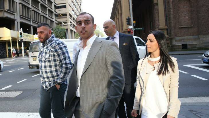 The accused murderer Mahmoud Barakat (second from left) leaves the NSW Supreme Court on Tuesday. Photo: Louise Kennerley