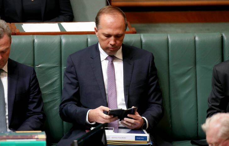 Minister for Immigration and Border Protection Peter Dutton checks his phone during Question Time at Parliament House in Canberra on Tuesday 3 May 2016. Photo: Alex Ellinghausen