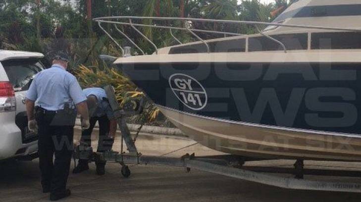 Police examine the boat that the five men towed from Melbourne to Cairns. Photo: Courtesy of Channel 7