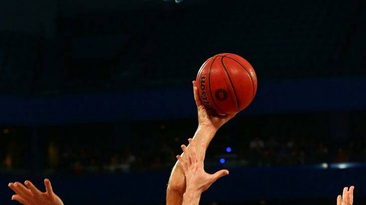 Perth Wildcat big man Matt Knight puts the ball up against Townsville's Brian Conkin during the round five NBL clash at Perth Arena  Photo: Paul Kane