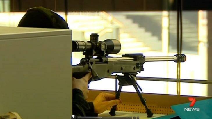 A sniper trains his gun on the Lindt cafe during the siege.  Photo: Channel Seven