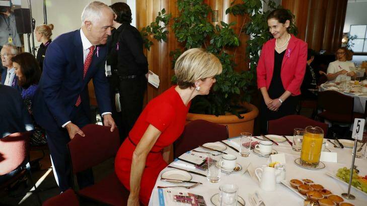 Prime Minister Malcolm Turnbull pulls the chair out for Minister for Foreign Affairs Julie Bishop during the International Women's Day 2017 Parliamentary breakfast at Parliament House on Thursday. Photo: Alex Ellinghausen