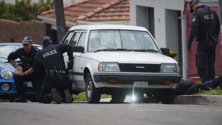Police continue to scour the scene in  Earlwood after Pasquale Barbaro was shot dead. Photo: Nick Moir