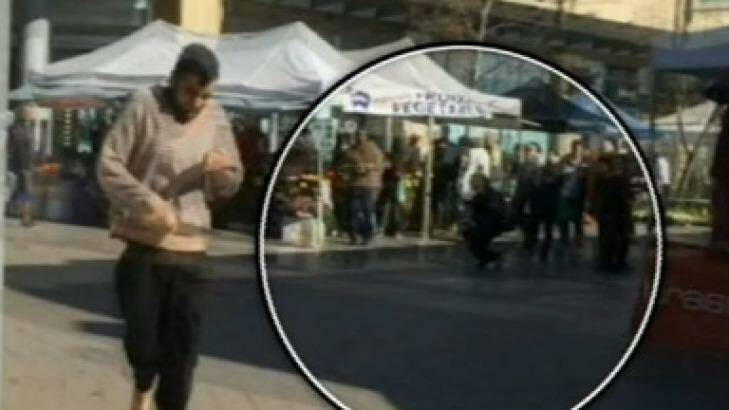 Alleged knife attacker Jerry Sourian at Westfield Hornsby with an injured bystander in the background. Photo: Channel 9