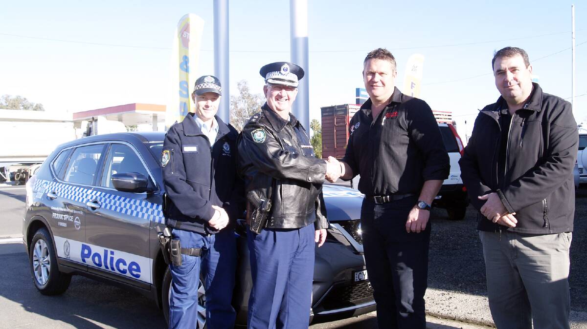 Senior Constable Daniel Greef and Superintendent Chris Taylor take possession of the new vehicle from Troy Hurford and Michael Spice.