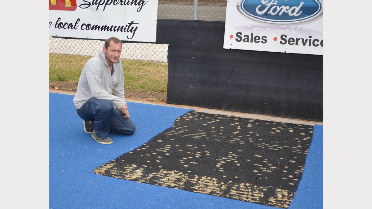 Parkes Hockey Executive Director Graeme Thompson inspects the patch of missing turf.  Photo: Denis Howard 0815turf1