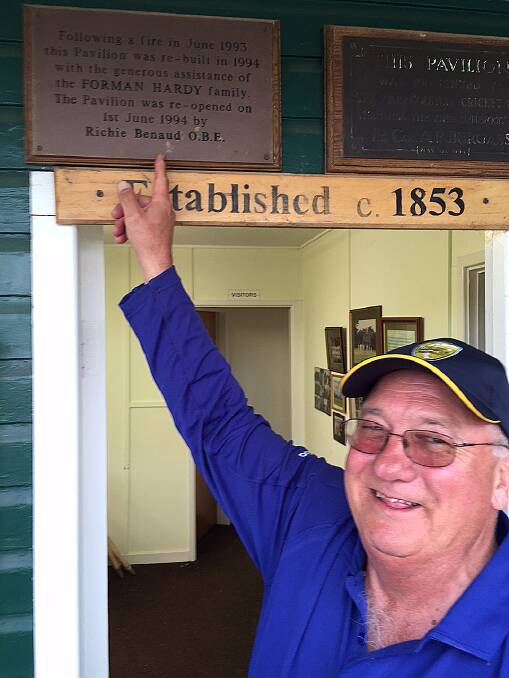 Local umpire Warwick Wheeldon points out the plaque which recognised Richie Benaud’s (OBE) opening of the new club house at Car Colston. Warwick was asked to umpire a local match on the largest village green in England. sub