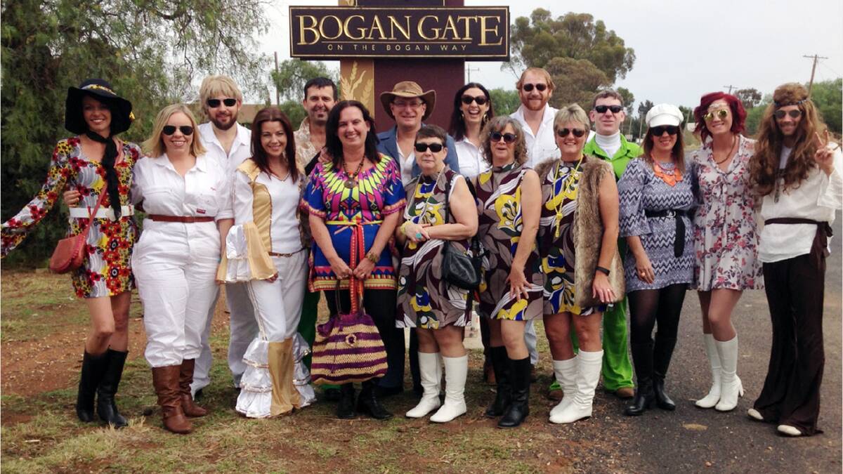 PICTURED - I doubt this group of locals had to look too far to get their outfits for the ABBA Festival.  They attend each year, stopping at Bogan Gate for their annual photo shoot. They are from left, Michelle Mikita, Rebecca Rawsthorne, Daniel Rawsthorne, Helen Rowbotham, Corey Rowbotham, Andrea Butler, Geoff Butler, Kim Horan, Anna Wyllie, Karen White, Angus Wyllie, Donna Payne, Ken Middleton, Orla Middleton, Kylie Bell, Vincent Bell.   