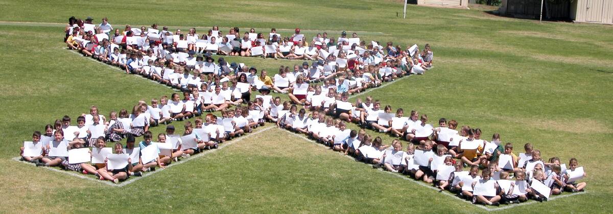 PICTURED - the students form a white ribon as part of the day’s activities.   