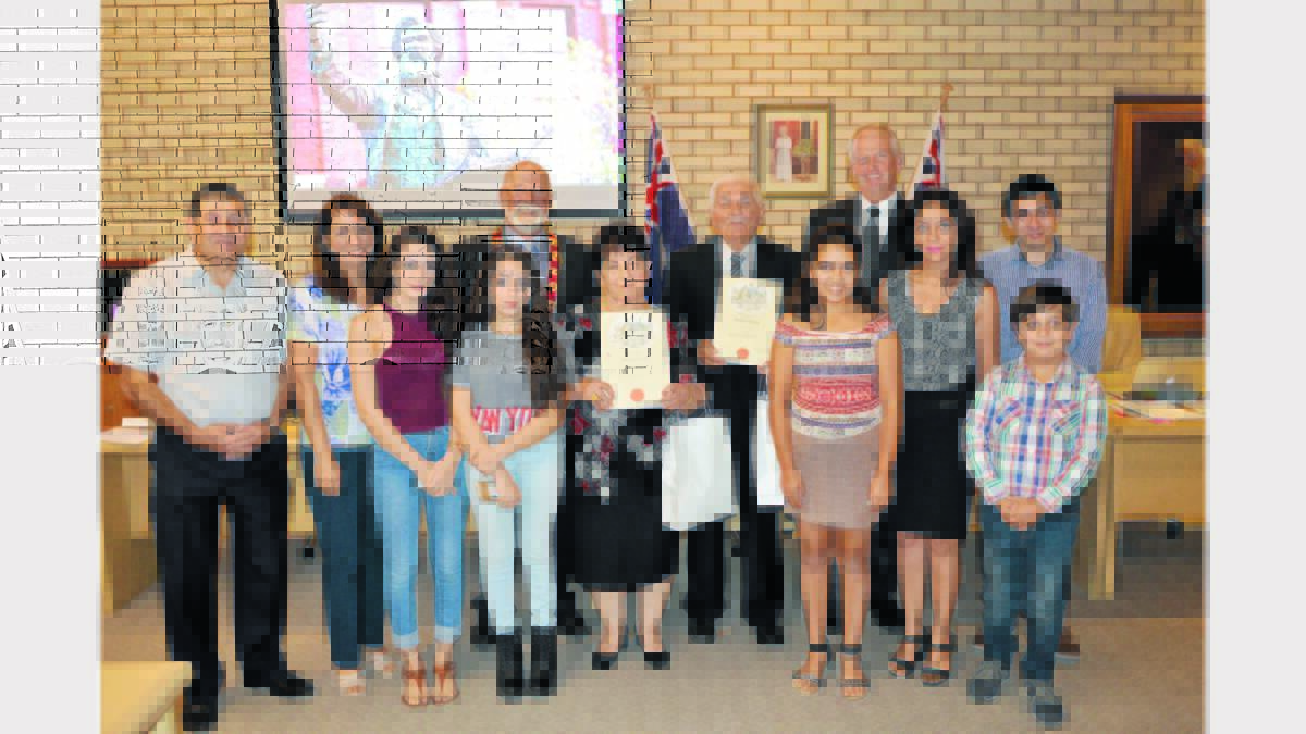 PICTURED - With the family supporters - Parkes’ newest Aussies Alexan Matti and wife Labeebah Shakarchi were surrounded by family and well-wishers following their Citizenship Ceremony - left to right, Basil Setrak (son-in-law), Thikra Kanan (daughter), Leen Setrak (grand-daughter), Marya Setrak (granddaughter), Labeebah and Alexan, Noor Fouad (granddaughter), Zaman Matti (daughter), Loay Setrak (grandson) and Yousif Fouad (grandson). Also pictured is Mayor Ken Keith who conducted the ceremony and Parkes Shire Council’s General Manager Kent Boyd.   Photo: Bill Jayet.  