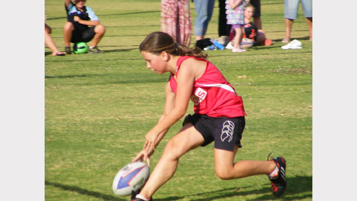 Chloe Drabsch, pictured scoring a try,  enjoyed last year’s touch football season.