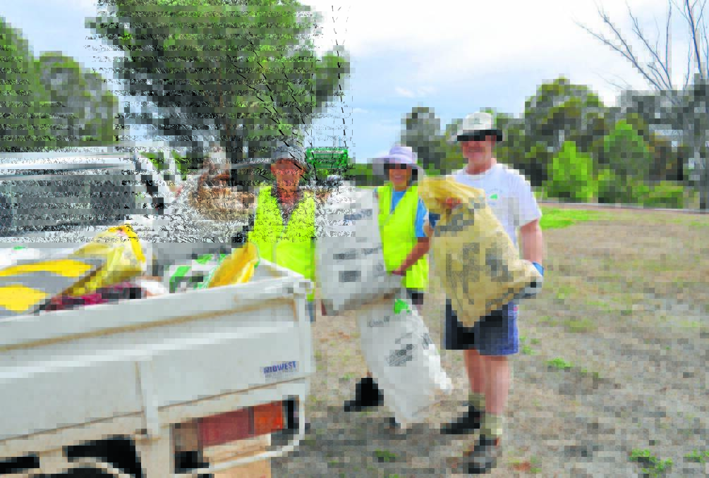 Clean up Australia Day activities scheduled for  Parkes last year were cancelled due to the wet conditions. Pictured are Bob and Bev Bokeyar, and David Bicket during the 2013 local clean up 