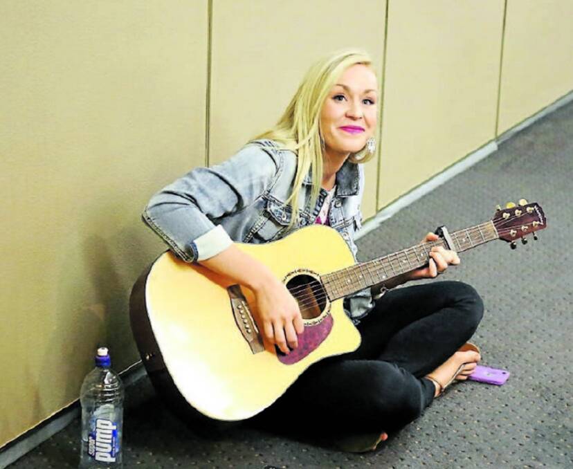 Parkes contestant, Alyssa Miller  strums away while waiting for her audition last weekend.   
