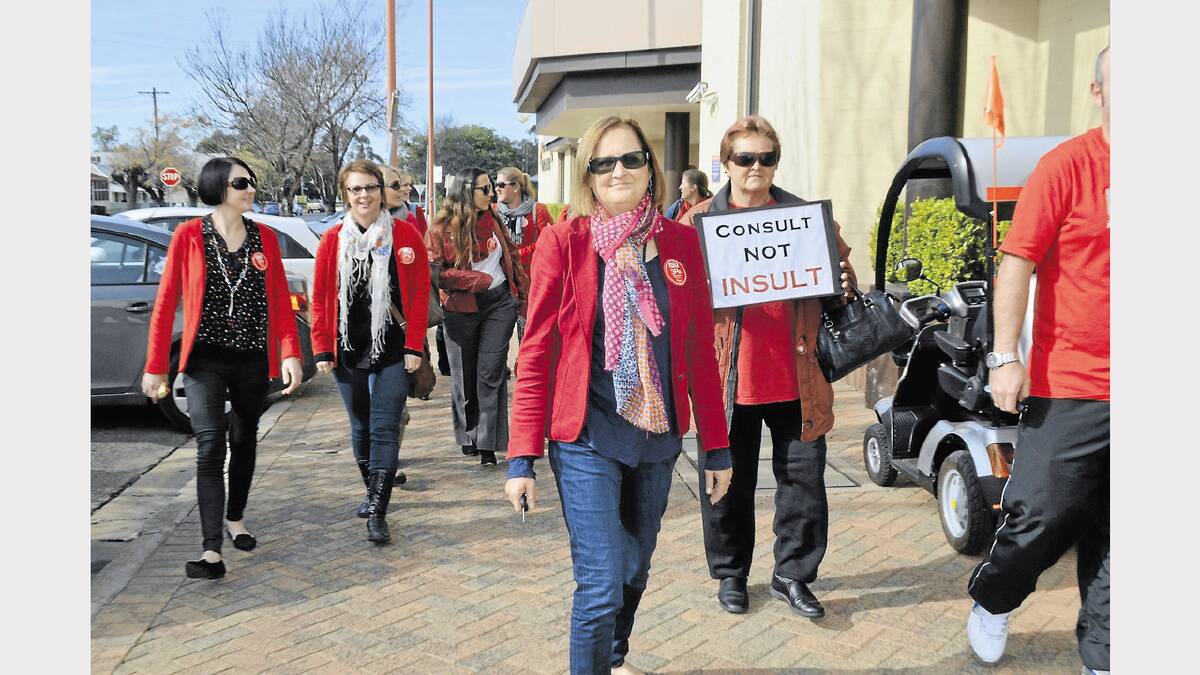 They all wore red, the union’s colour, and waved balloons and signs of protest as they walked the streets of Forbes.

