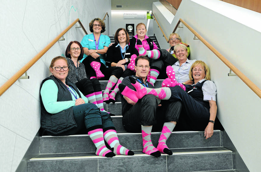 Parkes Hospital staff proudly displaying their socks - from left, Katrina Hall, Kristie McGrath, Janine Hando, Rebecca Evans, Di Green, Sandi Bailey, Carla Bishop, Pam Sharpe, and front middle, Russell Piercy. Photo: Bill Jayet