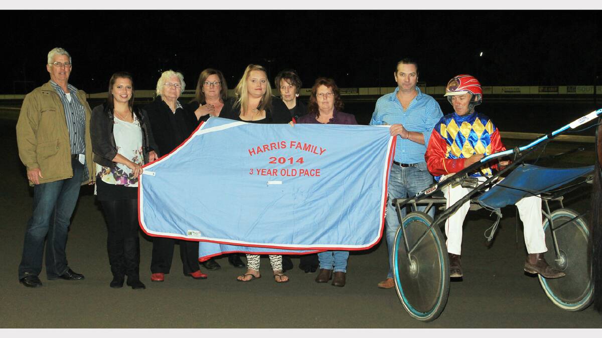 Regal Point scored a fast finishing win along the pegs in the Harris Family Pace at the Parkes Paceway last week.   Pictured from left are members of the Harris family,  Lionel Harris, Cody Wakefield, Julie Harris, Karen Rodgers, Skye Harris, Joy Wallace, Debbie Stephenson, Wilbur Harris and trainer- driver, Bernie Hewitt.