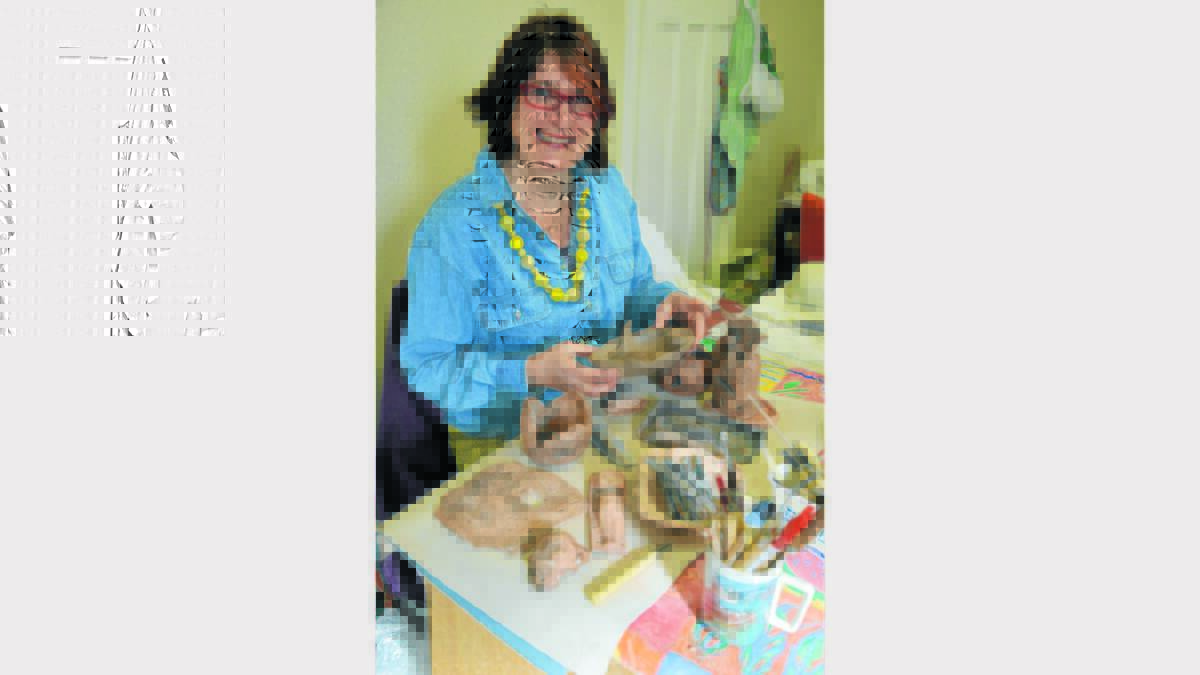 Parkes Pottery Group member, Jocelyn Moles prepares for this weekend’s exhibition.