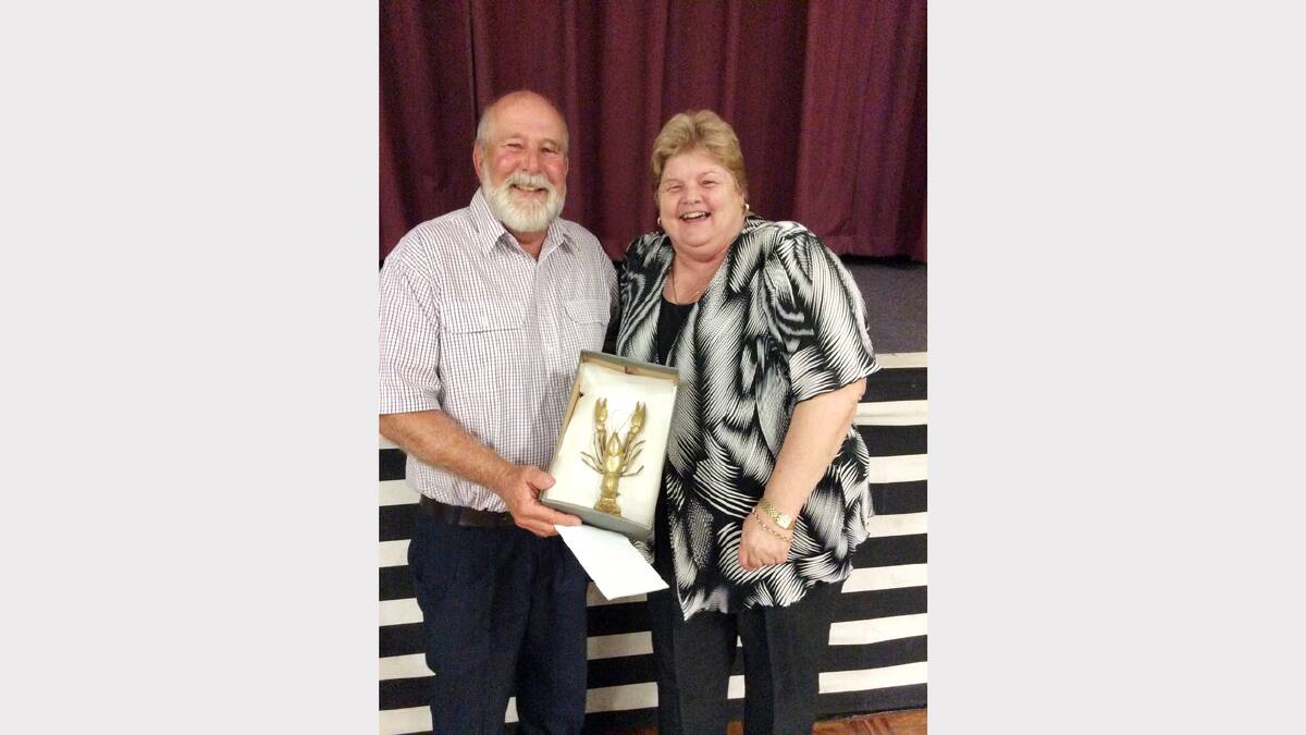 Mayor Ken Keith with the Golden Yabby, presented at the Elvis Festival trotting meeting, and Kim Ross.