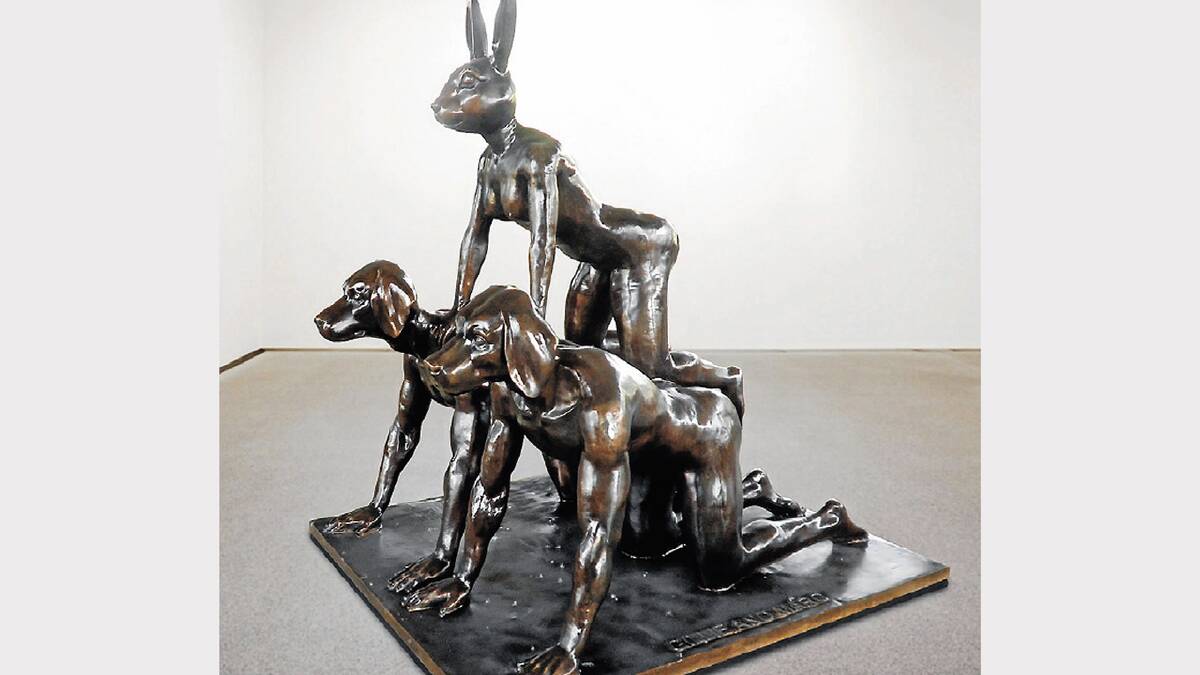 The life-size bronze sculpture loaned to Forbes by world-renowned sculptors Gillie and Marc features human bodies with dog and rabbit heads in a pyramid formation.