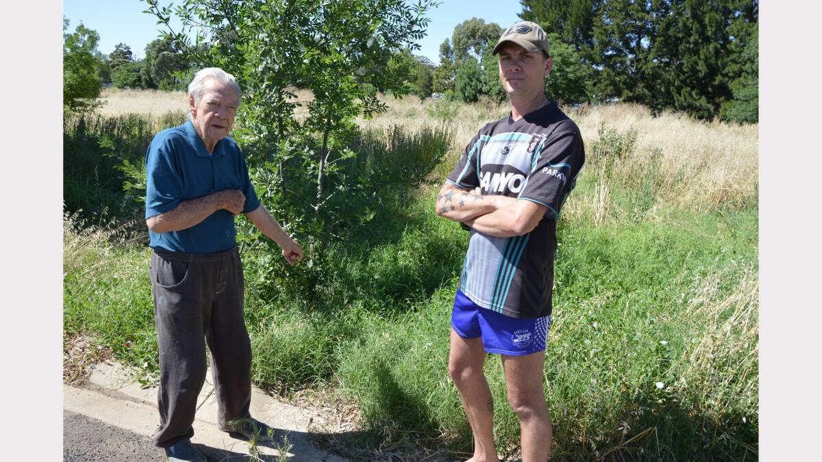 Austral Street residents, Bill Nolan and Guy Taylor are less than impressed with the lack of attention their street receives. Bill is pointing to a supposed drain in a paddock across the road which is always overgrown and a real fire hazard. 