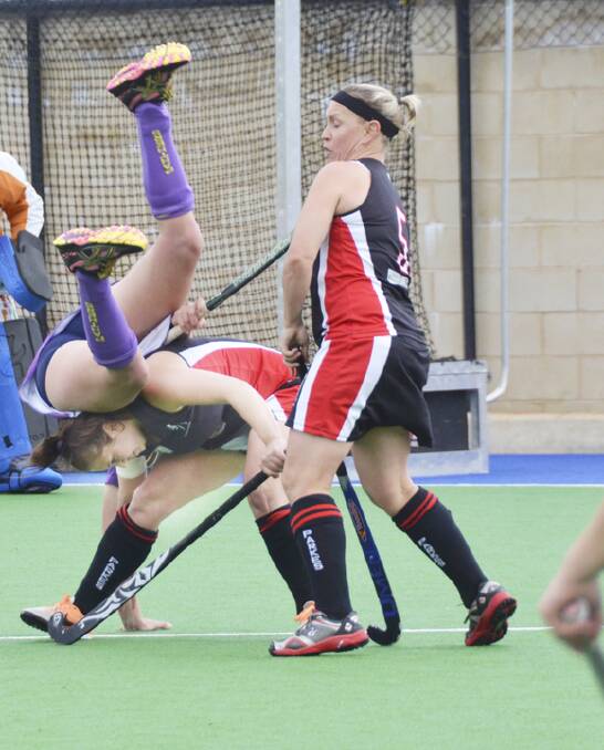 Madelyn Williams upends a Lithgow player as Wendy Rix tries to avoid contact.