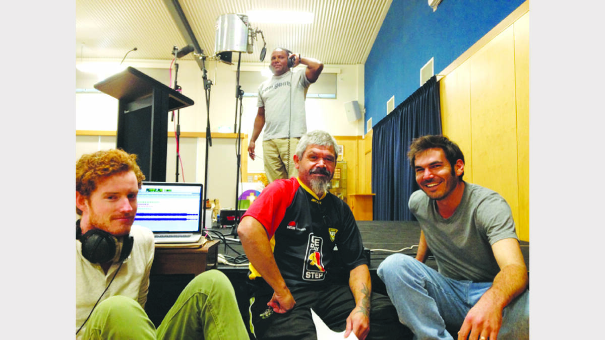 Lionel Lovett (back) of Parkes Public Primary School and Parkes Wiradjuri Language Group; and front, Sunfield and  Ub Ubbo members, Jason (Nacho) Murchie (music producer), Scott (Sauce) Towney, and Tom Orr recording Wiradjuri language at Holy Family Primary School. 
